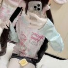 Long Sleeves Mezzo Piano T-Shirt with floral and character print design.