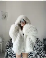 White Thick Fluffy Faux Fur Coat with hood, showing texture and detail.