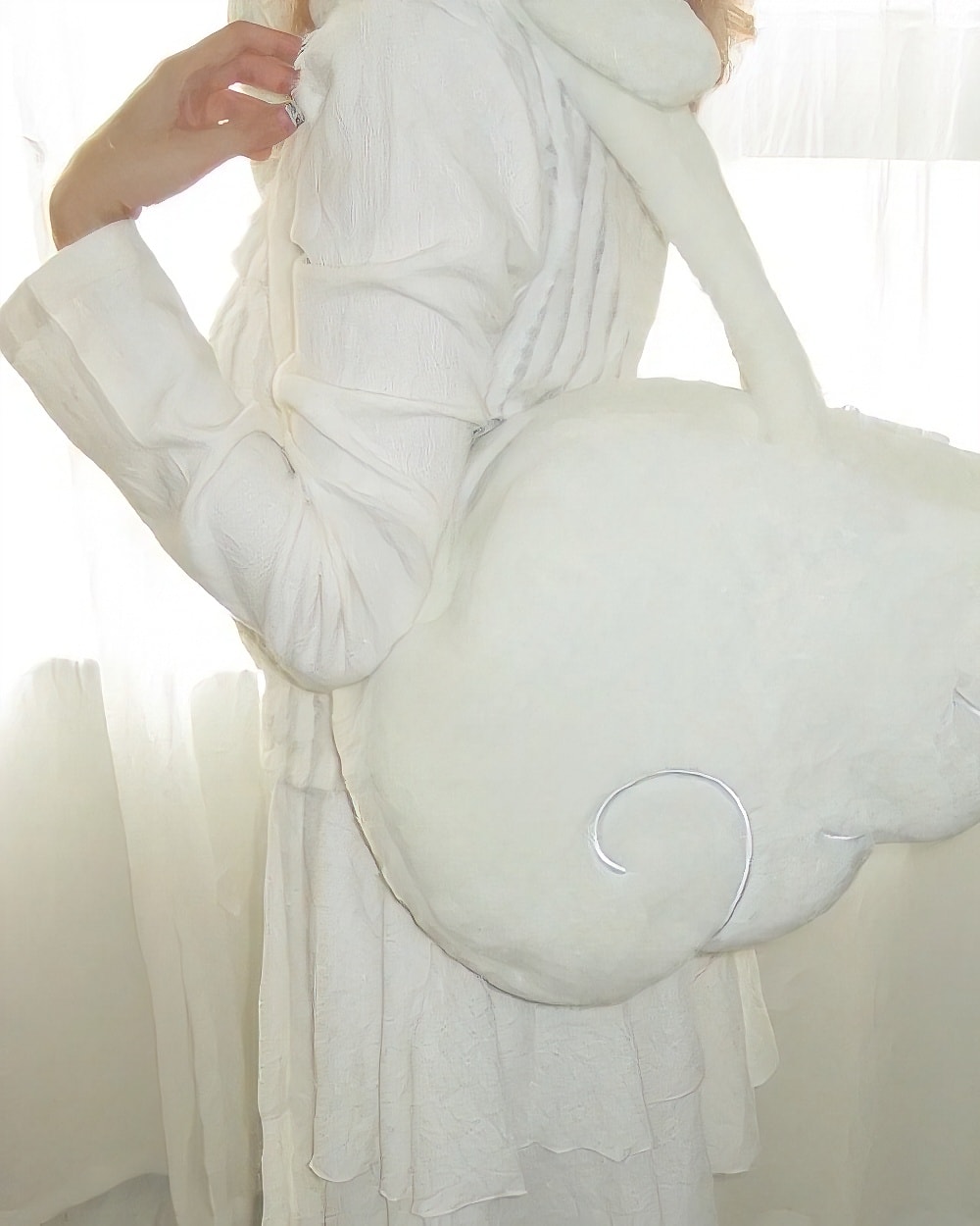 Close-up of a white Angel Wings Bag, Harajuku aesthetic.