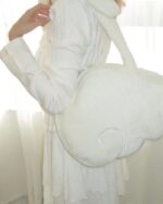 Close-up of a white Angel Wings Bag with fluffy texture, Harajuku aesthetic.