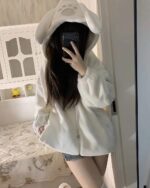 White Fluffy Bear Paw Hoodie worn by a person, featuring a hood and earmuffs.