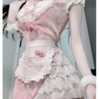 Close-up of a pink maid dress with lace details and ruffles. This Pink Maid Dress showcases a Dollette Aesthetic style.