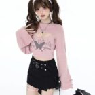 Fairy Grunge Set: Pink sweater with butterfly graphic and black skirt, thigh-high socks.