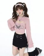 Fairy Grunge Set: Pink sweater with butterfly graphic and black skirt, thigh-high socks.