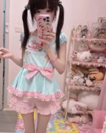 A person wearing a Cute Lolita Pastel Top - Jojifuku Aesthetic, featuring a pale blue dress with floral print and ribbons.