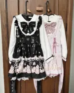 Three Jirai Kei Dresses in black, pink, and white, hung on a hanger.