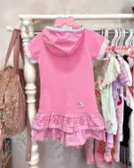 Pink Mezzo Piano Shirt on hanger with hood and layered skirt design.