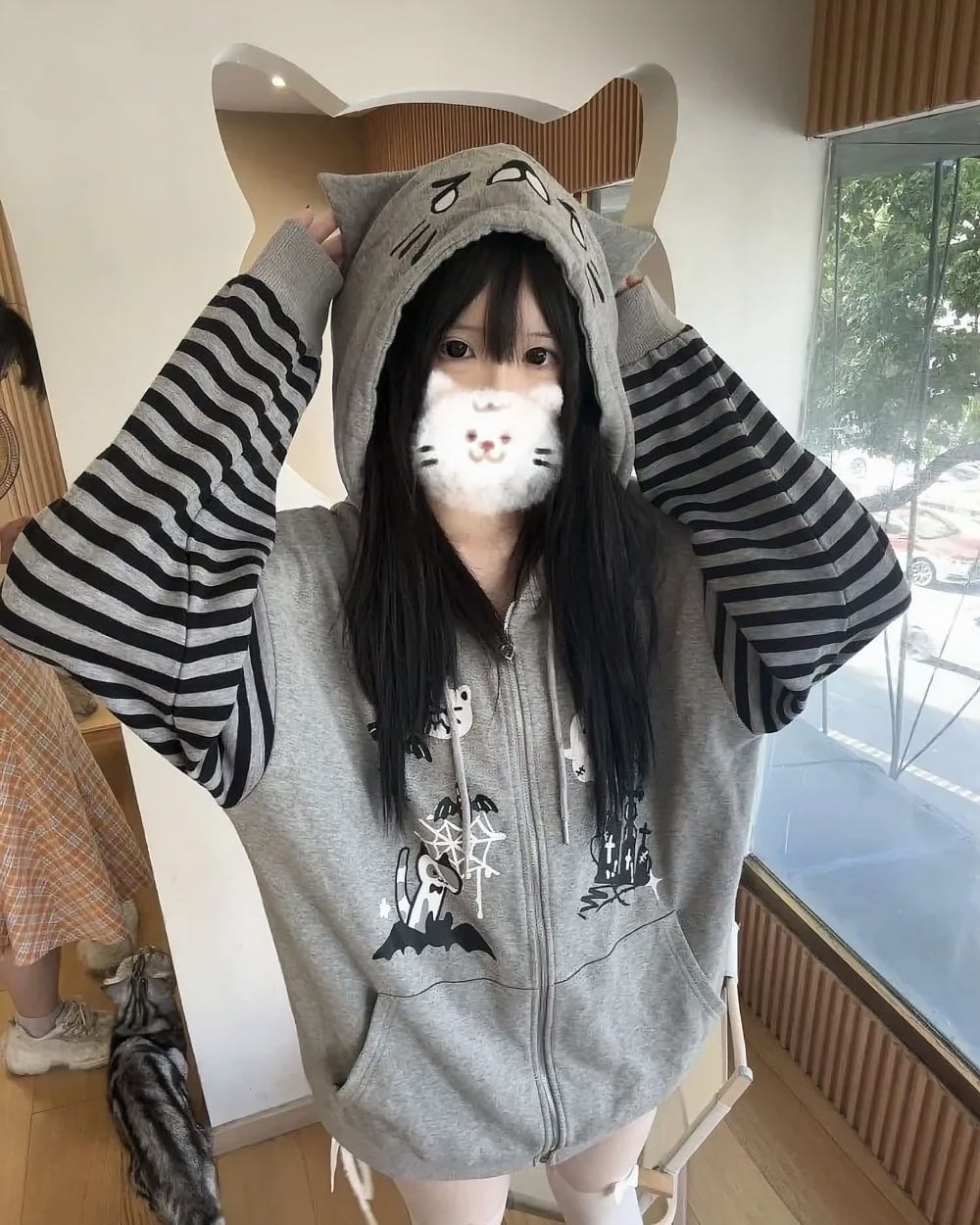Teary Neko Gray Hoodie - Halloween Edition product photo 1 Teary Neko Gray Hoodie - Halloween Edition Harajuku Cat Hoodie, featuring a cat face design and striped sleeves.