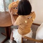 Person wearing a Kuma Zip Up Hoodie - Jojifuku Hoodie, holding a plush toy.