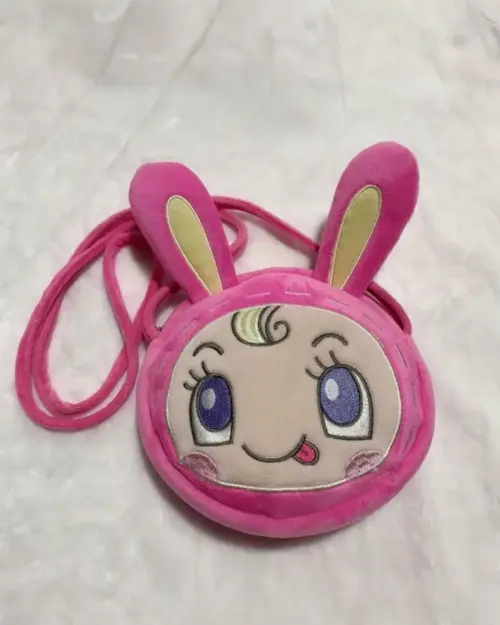 Close-up of a pink Mezzo Piano Cross Body Bag featuring a rabbit-shaped design and decorative details.