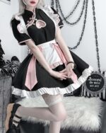 Detailed view of a black and white Kawaii Maid Dress cosplay outfit with lace and pink accents.