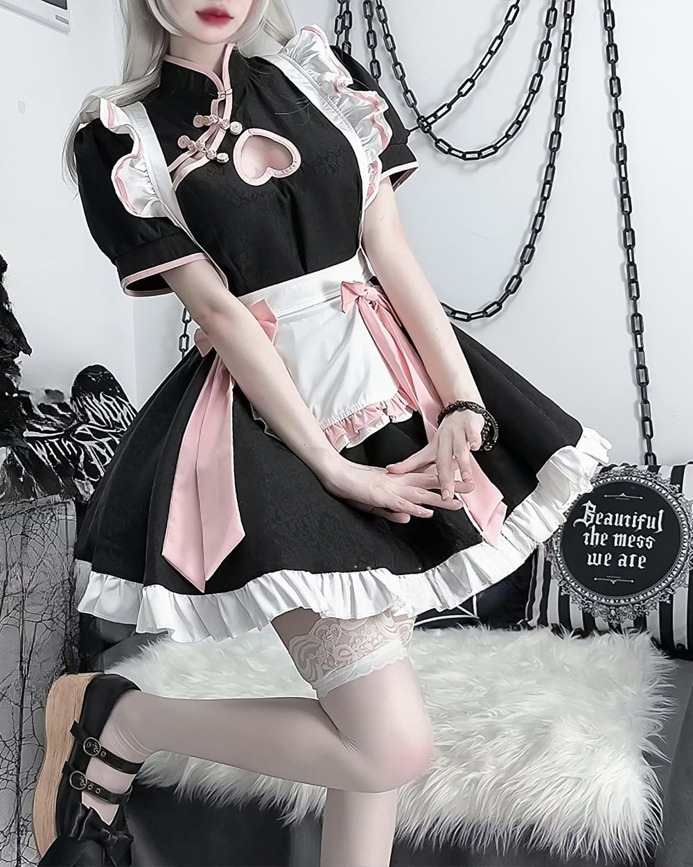 Detailed view of a black and white Kawaii Maid Dress cosplay outfit with lace and pink accents.