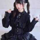 Model wearing a Dark Lolita Set - black blouse, skirt, and corset with lace details.