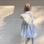 Fluffy Angel Wings Bag - Harajuku Aesthetic, a white plush bag worn by a model.