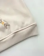 Close-up of an Ethno-Chic Hoodie sleeve detail, featuring ribbed cuffs and embroidery.