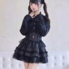 Model wearing a **Dark Lolita Set** – black ruffled blouse, corset, and skirt with lace trim.
