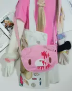 Close-up of a pink Gloomy Bear Plush Bag, decorated with plush elements and patches.