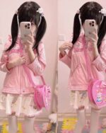 Pink Heart Shaped Cross Body Bag worn by a model, Jojifuku aesthetic.