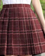 Close-up of a maroon JK Plaid Skirt with white checks, featuring a pleated design.