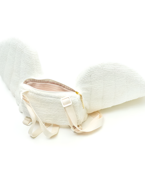 White angel wing backpack featuring plush material and zipper closure.