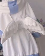 Close-up of white angel wing backpack, featuring plush wings and a hooded design.