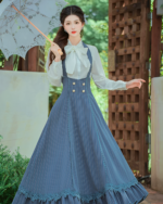 Woman wearing Archive Pinstripe Pinafore Set, an academia aesthetic outfit with a long skirt and white blouse.