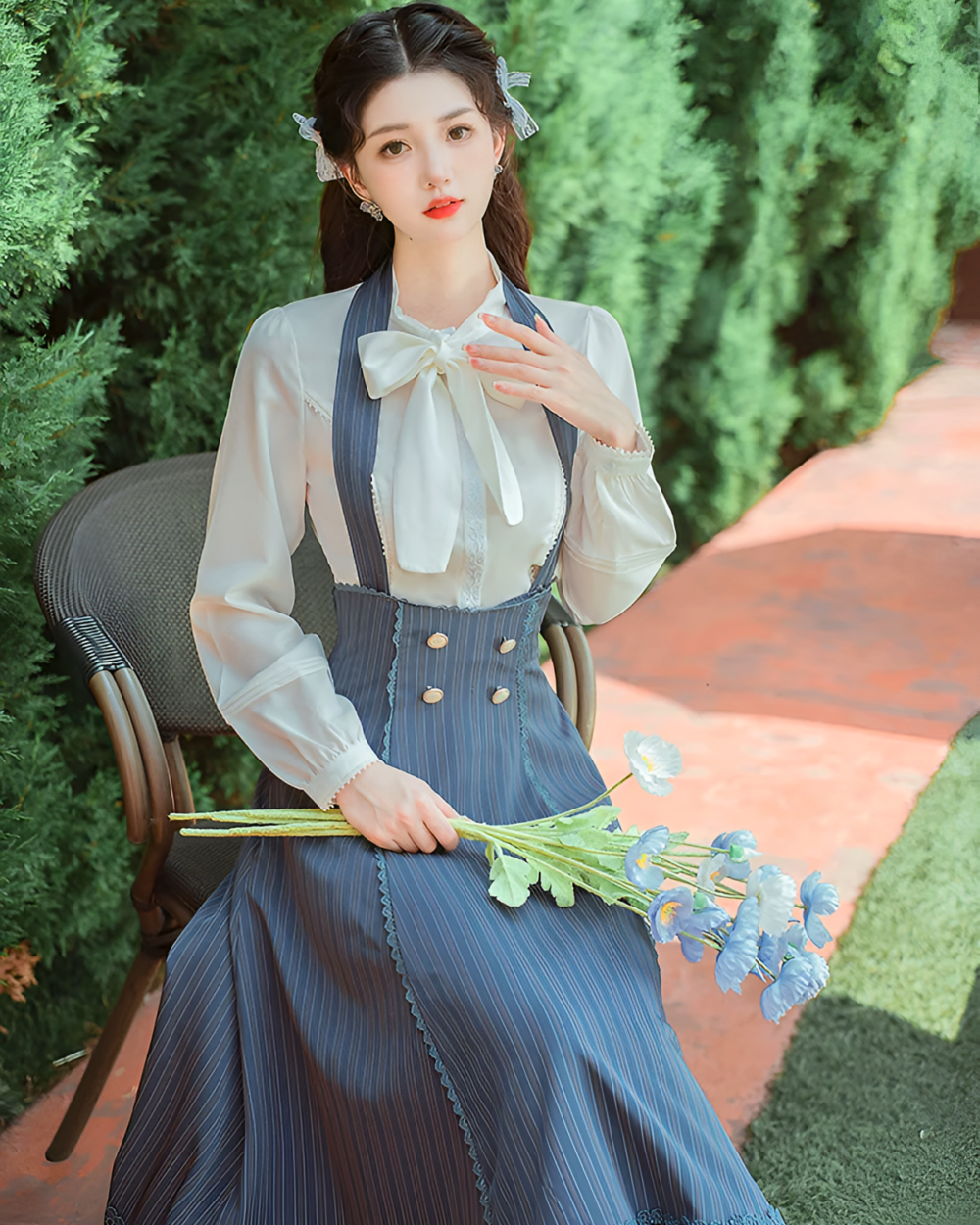 Woman wearing the Archive Pinstripe Pinafore Set, featuring an academia aesthetic style with a white blouse.