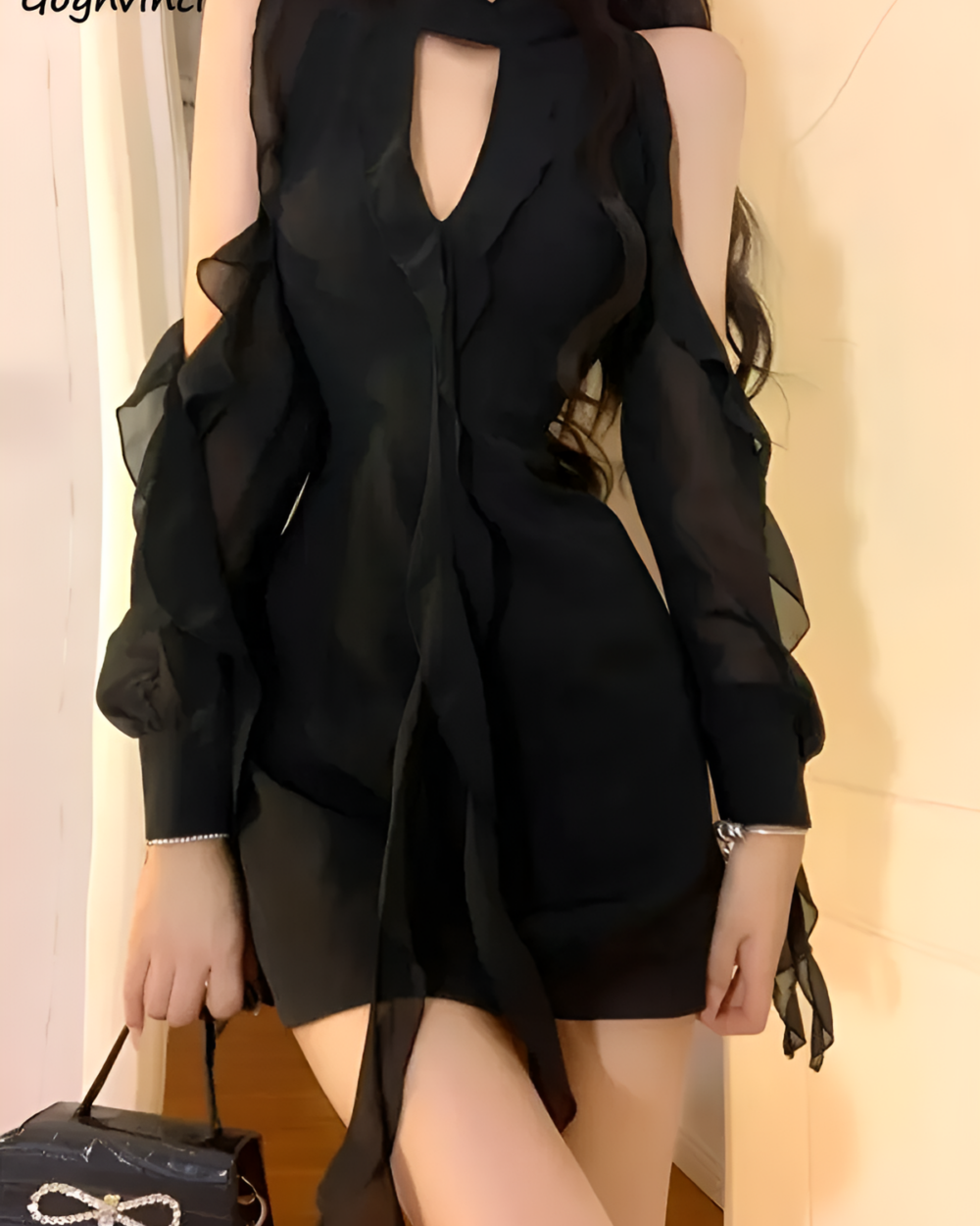 Black Coquette Dress featuring a hollowed-out design and ruffled sleeves.