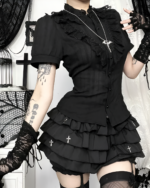 Black ruffled blouse with gothic aesthetic detailing, featuring lace trim and layered ruffles.
