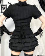Black ruffled gothic aesthetic blouse with lace trim and a tied waist detail.