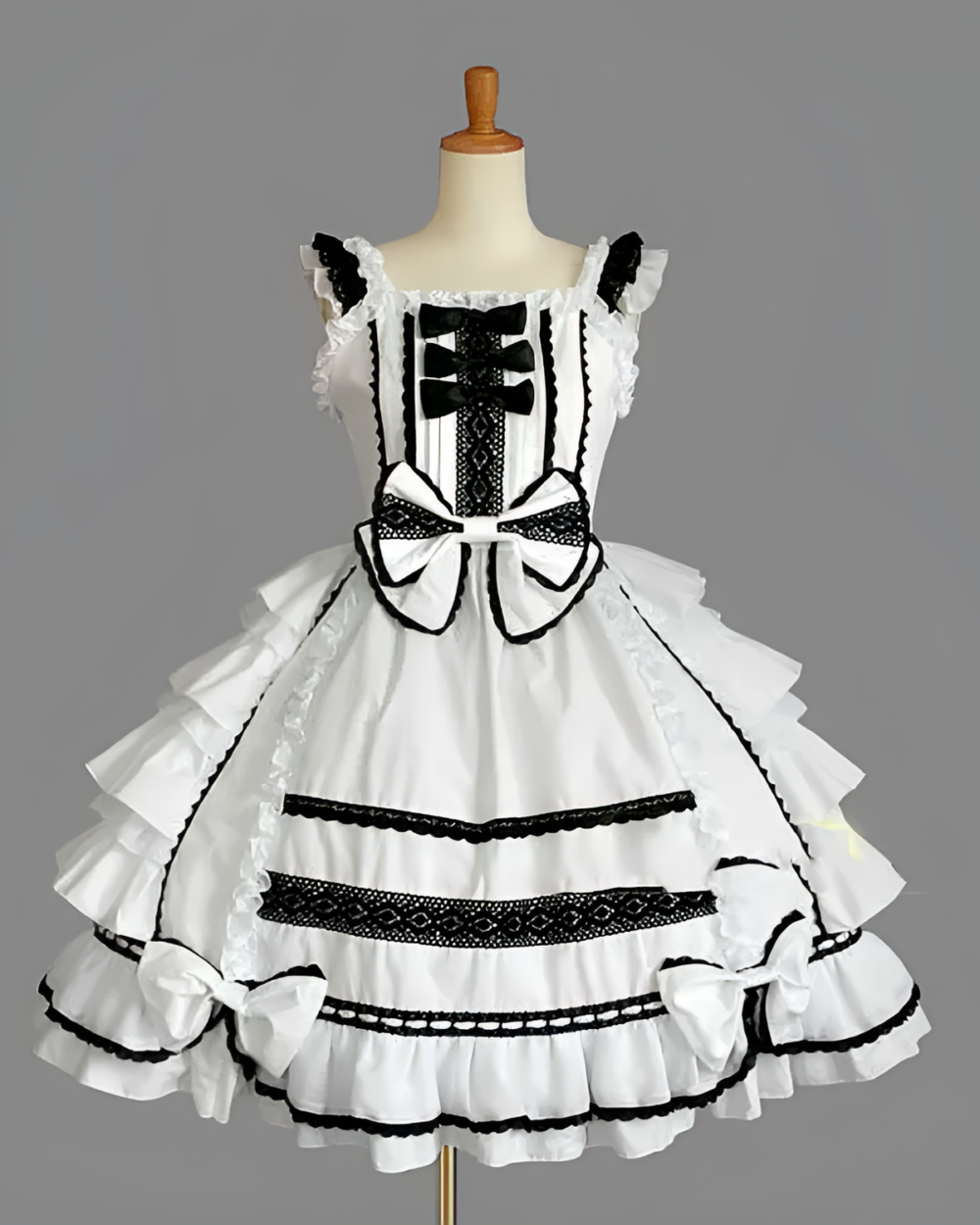 Black and white Hime Lolita dress with ruffled skirt and lace details displayed on a mannequin.