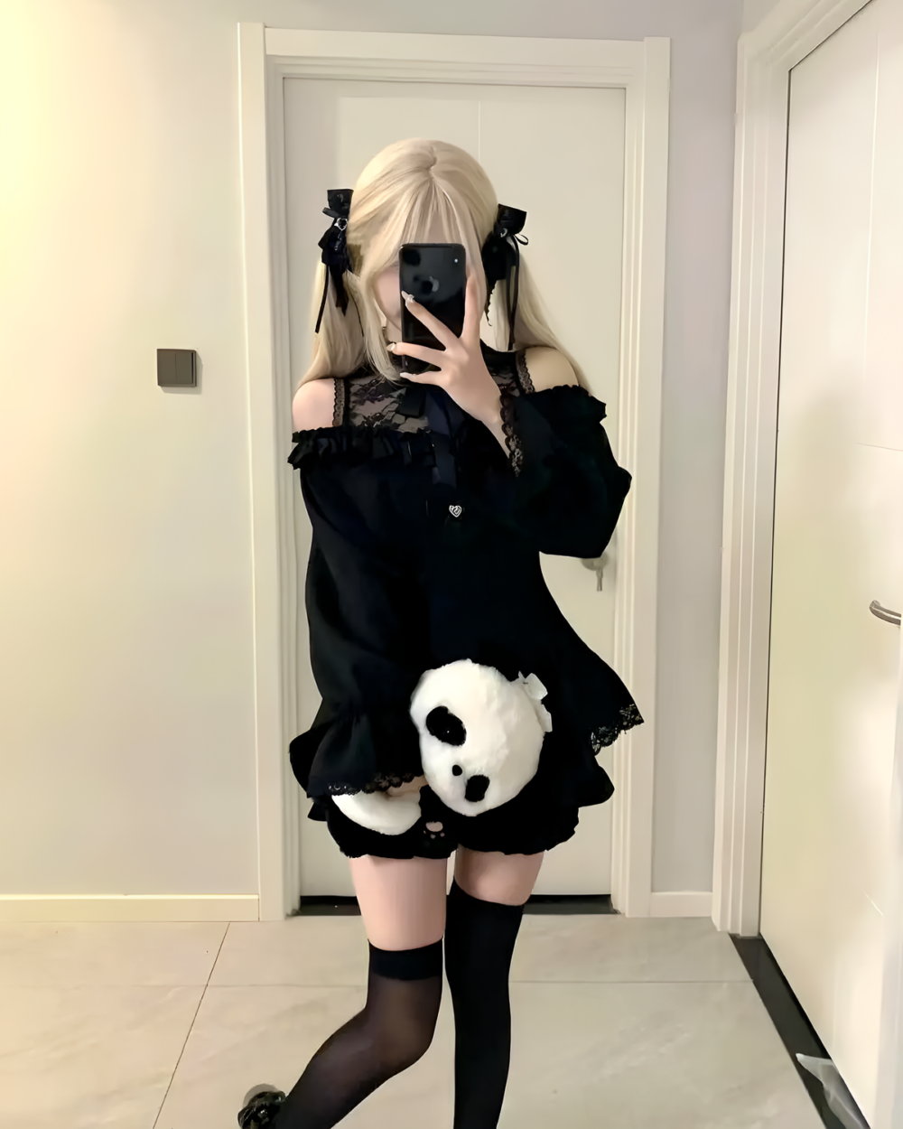 Model wearing a black Bowed Mini Dress, a Gothic Lolita dress with lace details and a panda plushie.