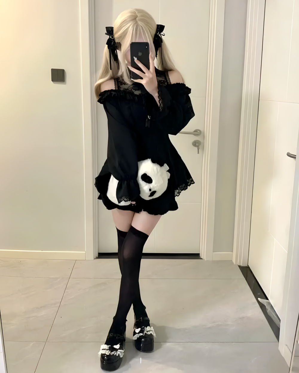 Model wearing a black Bowed Mini Dress - Gothic Lolita Aesthetic. This Gothic Lolita dress features lace details and a skull graphic.