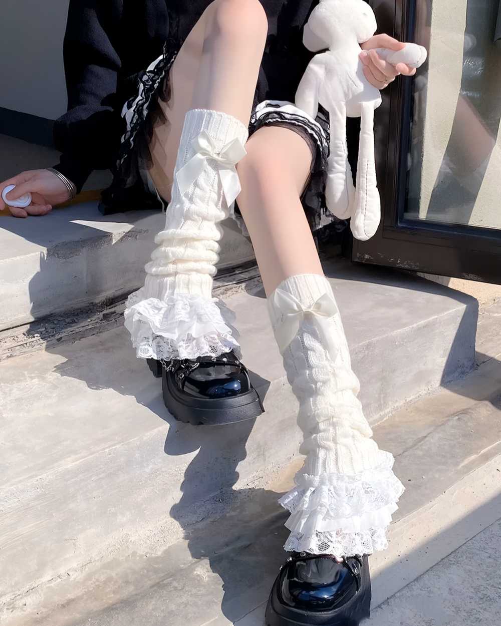 White ruffled leg warmers with lace trim, featuring a Hime Gyaru aesthetic style.