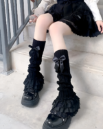 Black ruffled leg warmers with bows, Hime Gyaru aesthetic style.