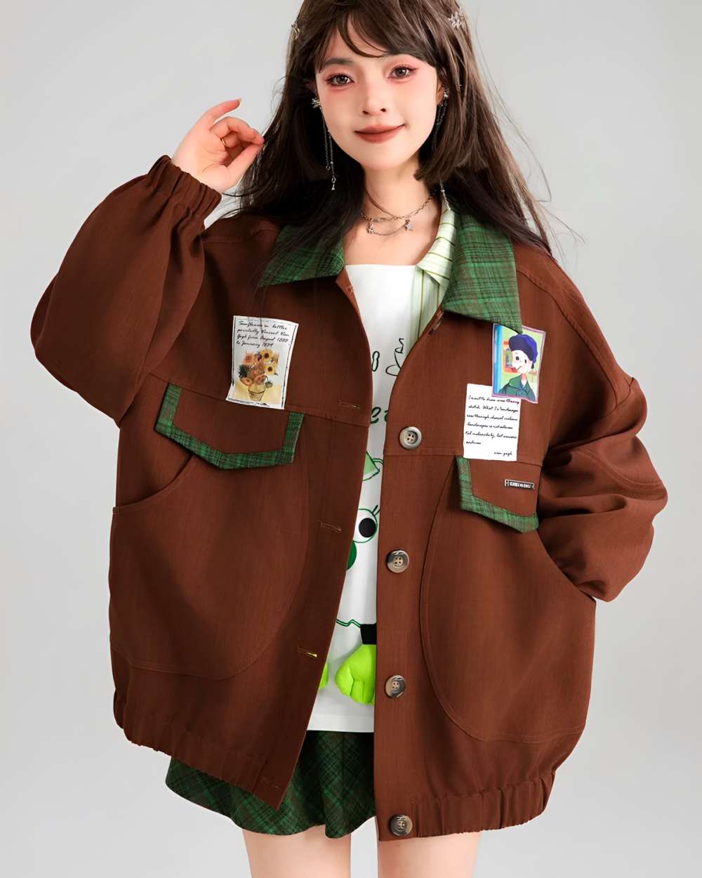 A brown corduroy jacket with decorative patches and buttons, featuring a preppy style.
