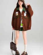 Brown corduroy jacket worn by a model with layered outfits and accessories.