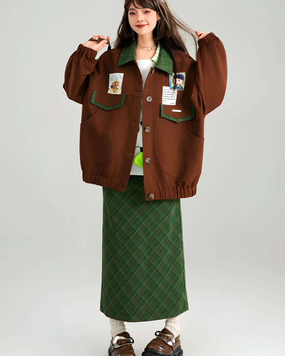 A brown corduroy jacket with decorative patches is worn by a model. Preppy aesthetic style.