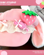 Pink COISINI STUDIO strawberry bunny cap with strawberry embellishment and ribbon.