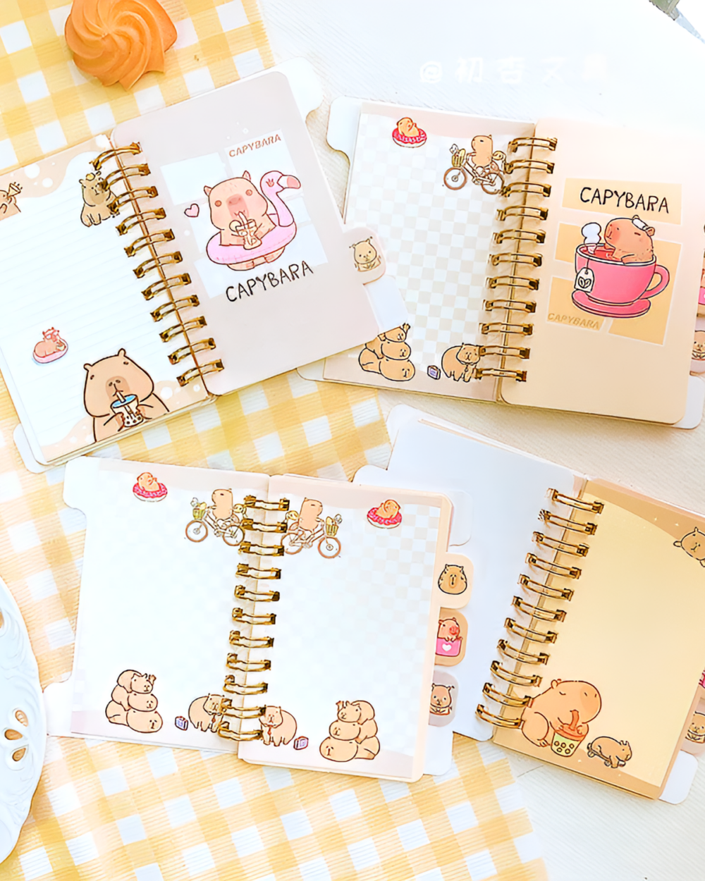 Multiple Capybara Notebooks displayed with cute illustrations and a checkered pattern.