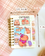 Close-up of a Capybara Notebook featuring illustrations of capybaras and stickers.