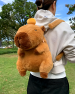 Person wearing a brown Capybara Plushie backpack outdoors. The plush backpack features a realistic capybara design.