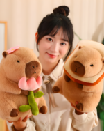 A woman holding two capybara plushies: one with a flower and another resembling a sandwich. These are from the Nature Explorer Edition.