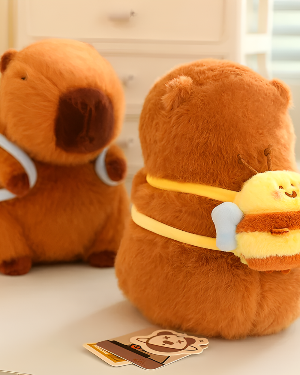 Two brown capybara plushies from the Nature Explorer Edition, with a tag and a card. Featuring a cute capybara plushie design.