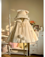 Cream Cat Eared Winter Cloak displayed on a mannequin with a soft, furry hood and tie closure. Ideal for cold weather.