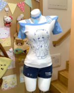 Cat Girl Nurse T-Shirt displayed with plush toys and accessories.