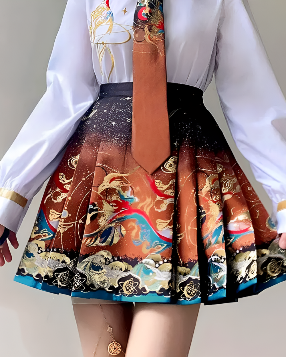 Woman wearing a white blouse and a brown and black celestial pleated skirt with a swirling galaxy print.