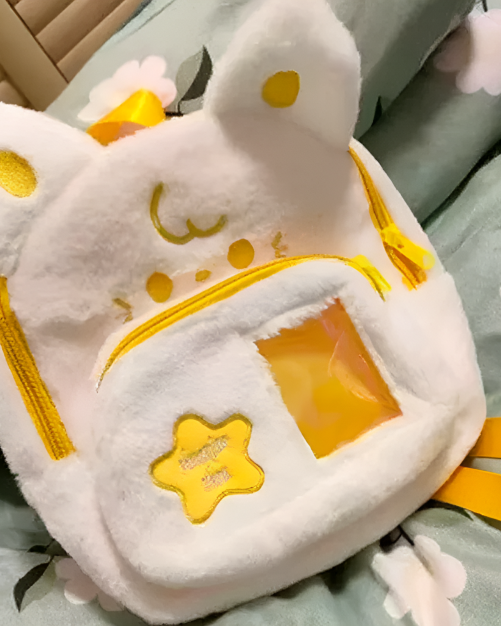 Close-up of a white Chibi Plush Backpack with star details, featuring a Jojifuku aesthetic. It has a yellow front pocket.