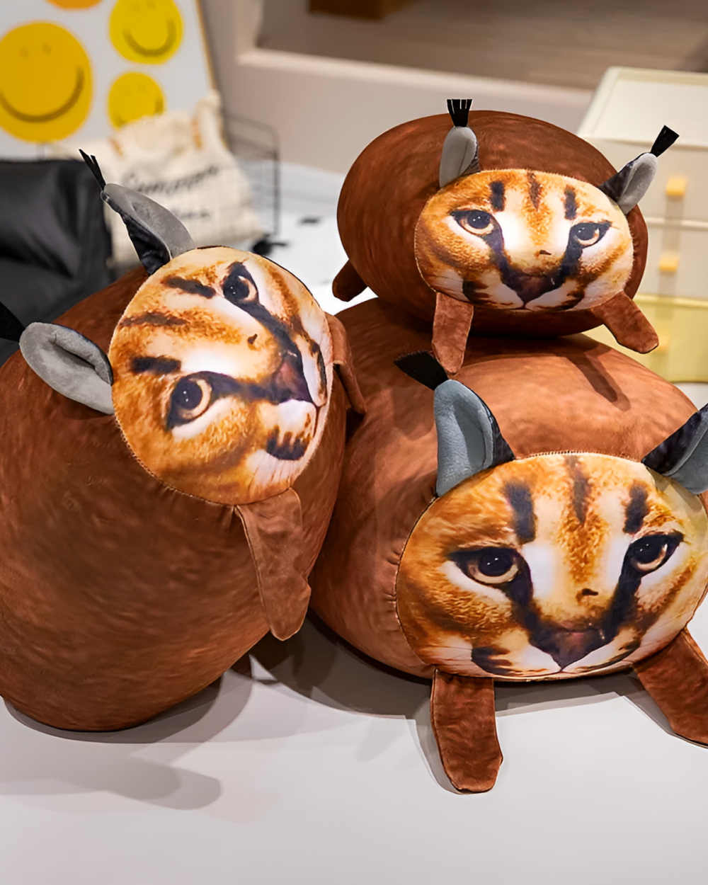 Chonky Big Floppa plushie displayed on a shelf with other plush toys.