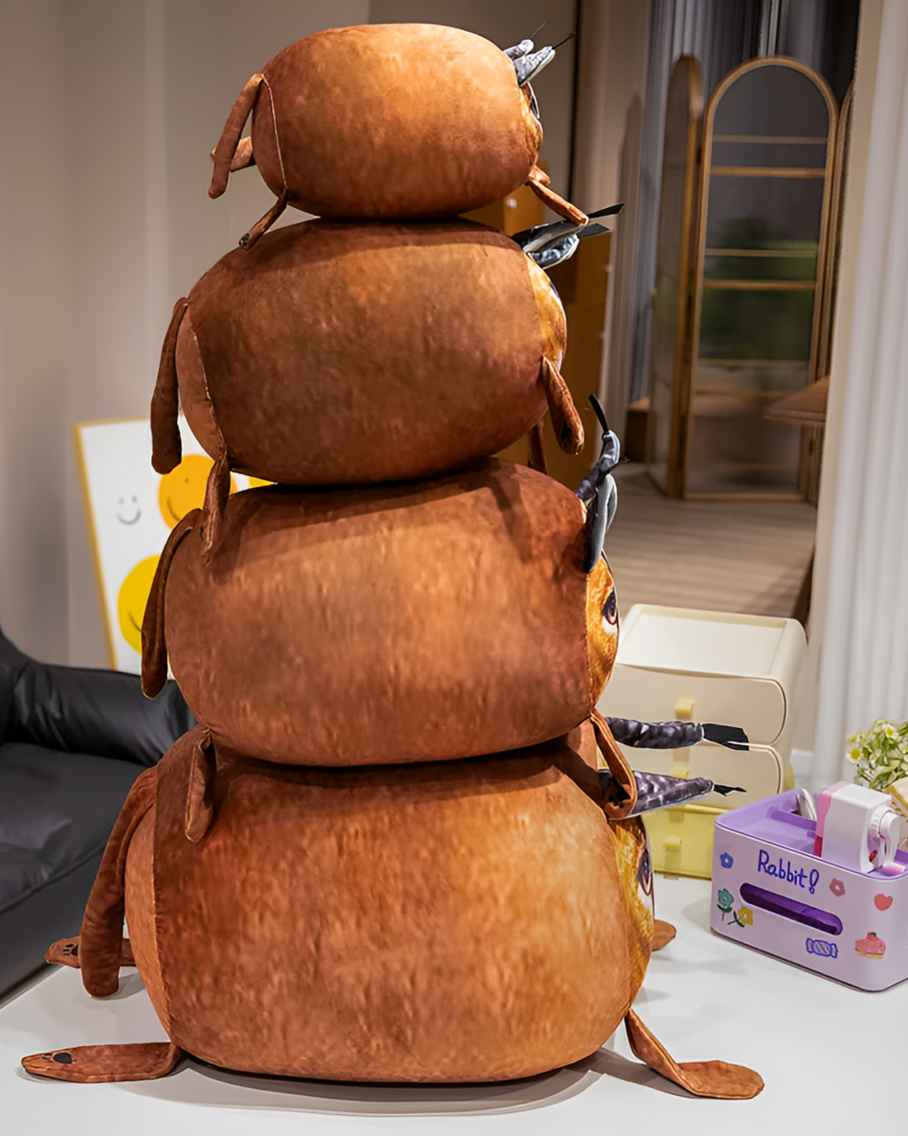 Stacked Chonky Big Floppa plushie toy displayed on a table with other decorative items.